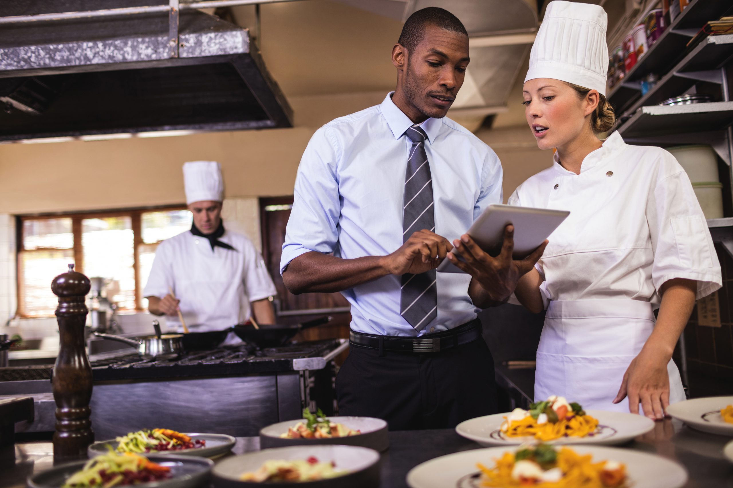 manager and chef with tablet