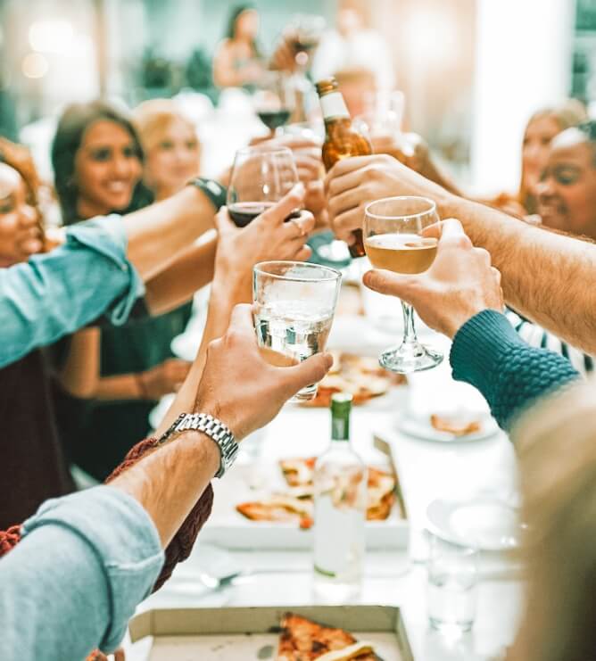 full dining table with people raising glasses