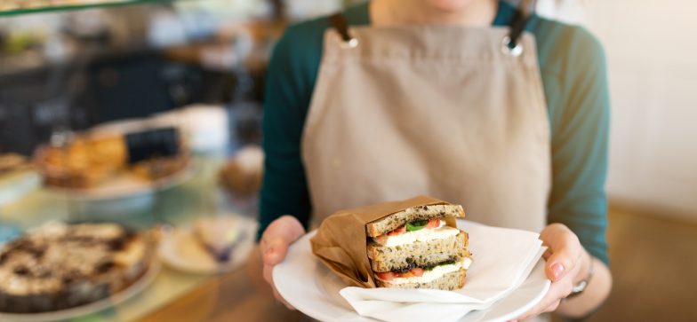 woman holding sandwich