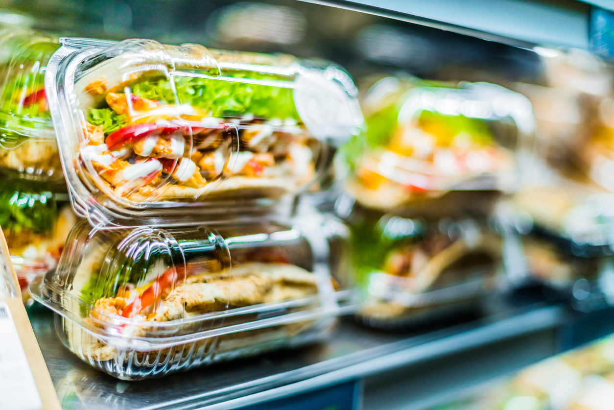 chicken with pita sandwiches stacked in to go containers