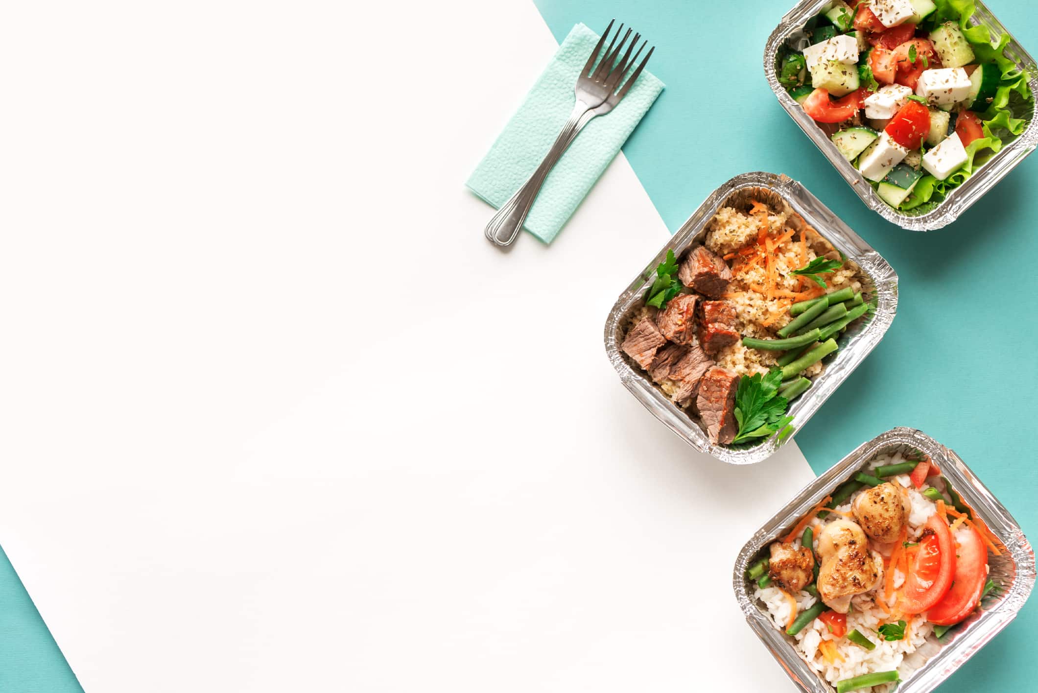 three foil dishes filled with healthy food