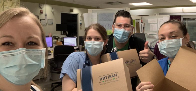 group of workers gather to prepare food packages during the covid-19 pandemic