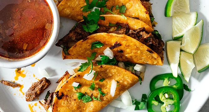 Biarra Tacos, Stew, and Lime wedges, top view