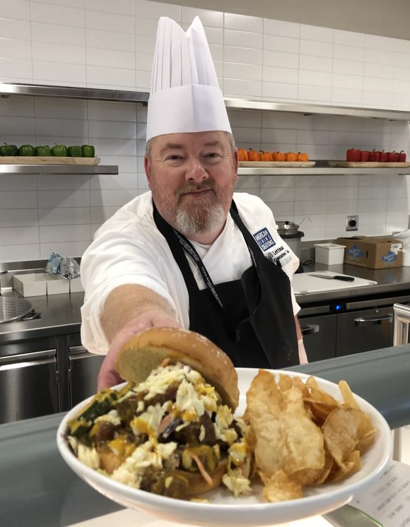 chef serving sandwich